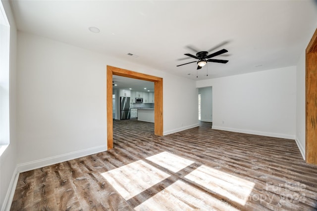 spare room with wood-type flooring and ceiling fan