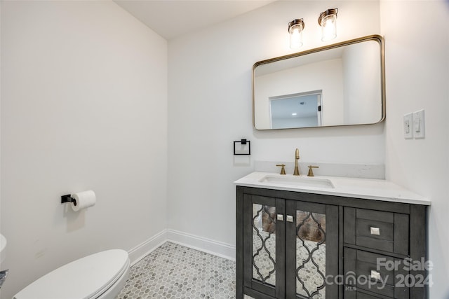 bathroom with tile patterned floors, vanity, and toilet