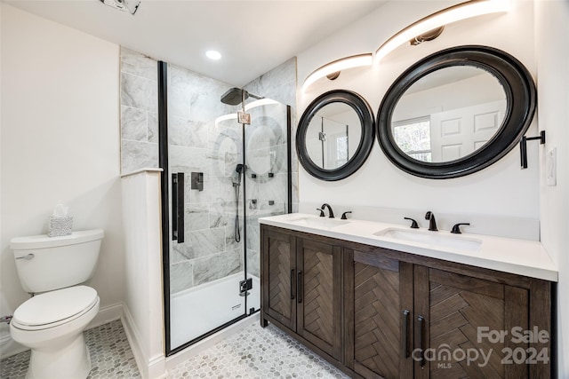 bathroom featuring tile patterned floors, vanity, toilet, and an enclosed shower