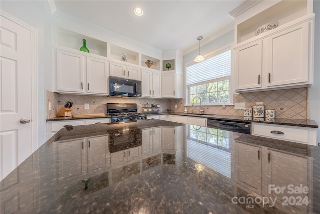 kitchen featuring stainless steel appliances, sink, pendant lighting, and white cabinets