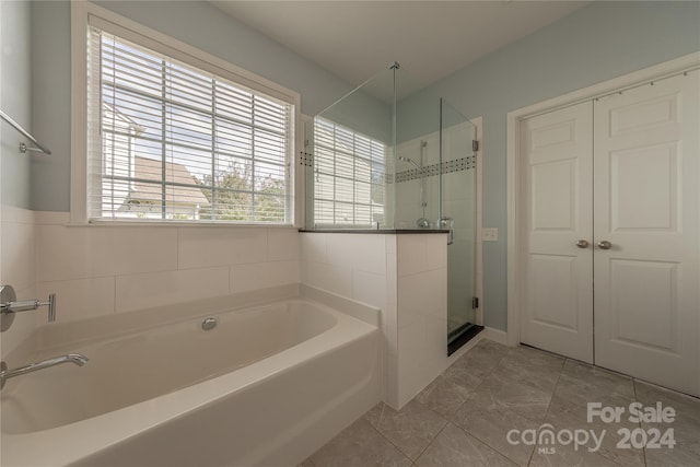 bathroom with plenty of natural light and plus walk in shower