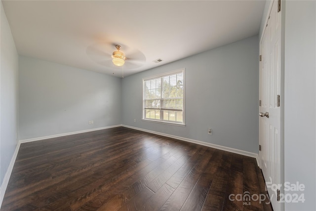 spare room with ceiling fan and dark hardwood / wood-style floors