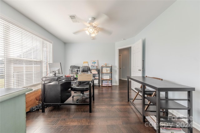 home office with ceiling fan and dark hardwood / wood-style flooring