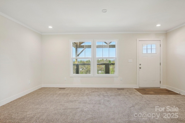 entryway featuring carpet and ornamental molding