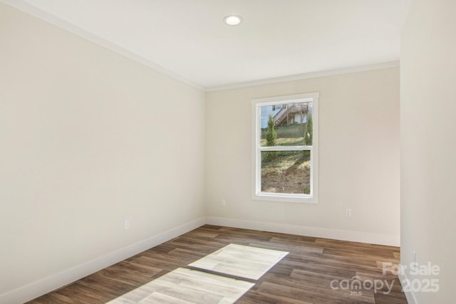 unfurnished room featuring dark hardwood / wood-style flooring and ornamental molding