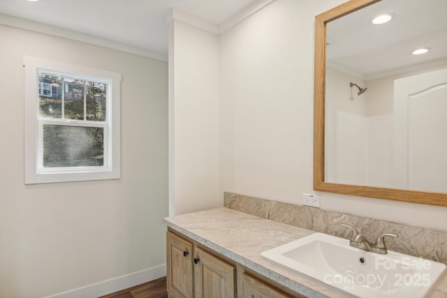 bathroom with crown molding, hardwood / wood-style floors, vanity, and walk in shower