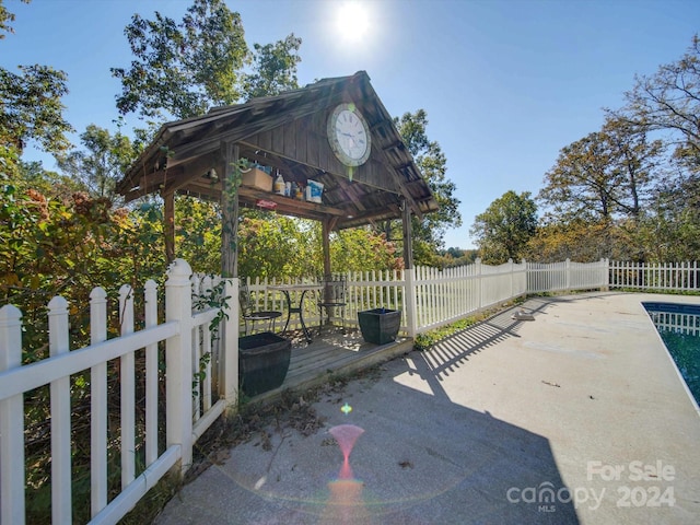 view of patio / terrace with a gazebo and a swimming pool side deck