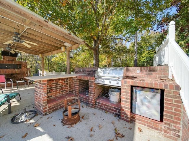 view of patio with exterior bar, exterior kitchen, grilling area, and ceiling fan