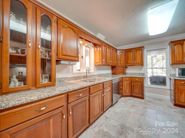 kitchen featuring decorative backsplash, a textured ceiling, stainless steel appliances, crown molding, and sink