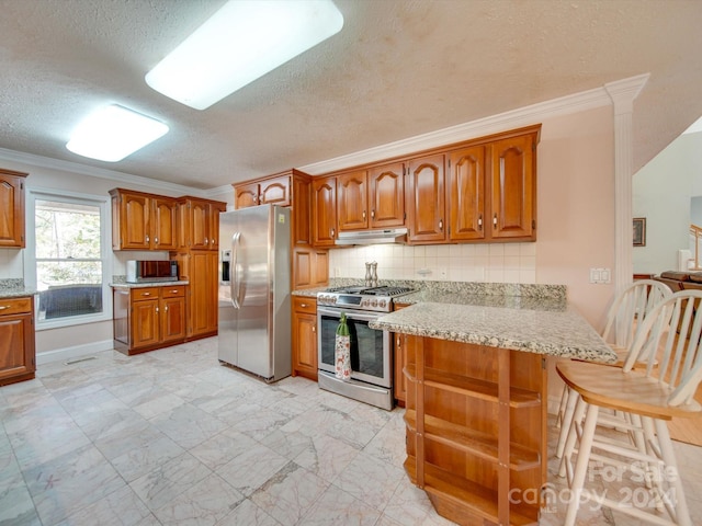 kitchen with decorative backsplash, kitchen peninsula, stainless steel appliances, ornamental molding, and a textured ceiling