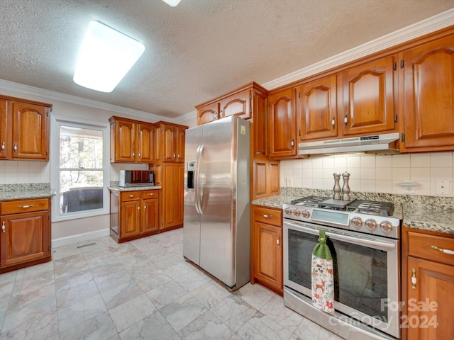 kitchen with backsplash, a textured ceiling, stainless steel appliances, light stone counters, and ornamental molding