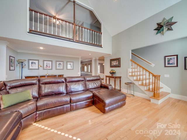 living room with ornamental molding, high vaulted ceiling, and wood-type flooring