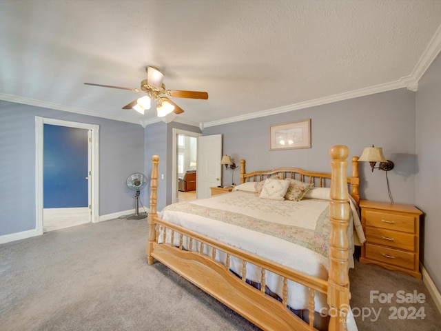 carpeted bedroom with ornamental molding, a textured ceiling, and ceiling fan