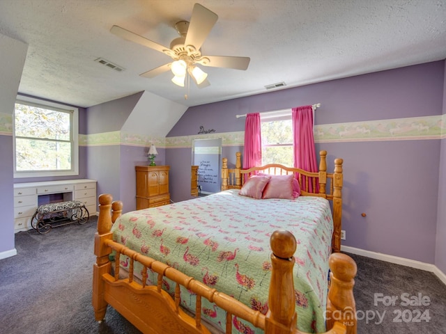 carpeted bedroom with a textured ceiling, vaulted ceiling, and ceiling fan