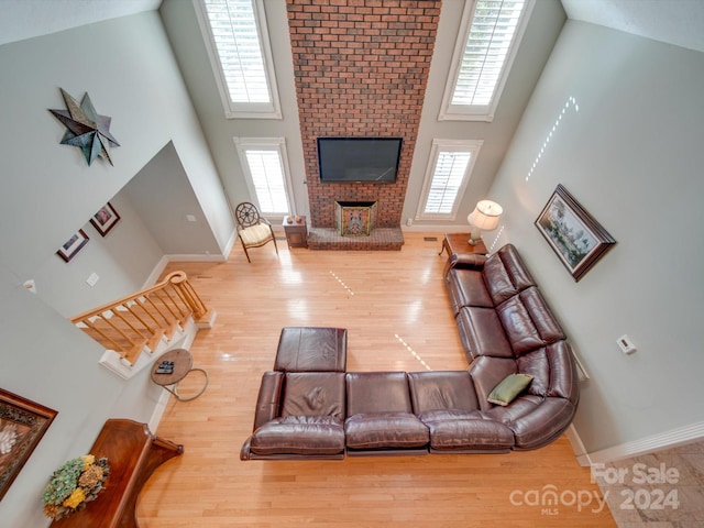 living room featuring hardwood / wood-style floors, a healthy amount of sunlight, and a high ceiling