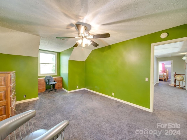 bonus room featuring a textured ceiling, carpet flooring, vaulted ceiling, and ceiling fan