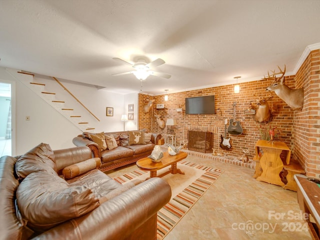 living room featuring brick wall, a fireplace, and ceiling fan