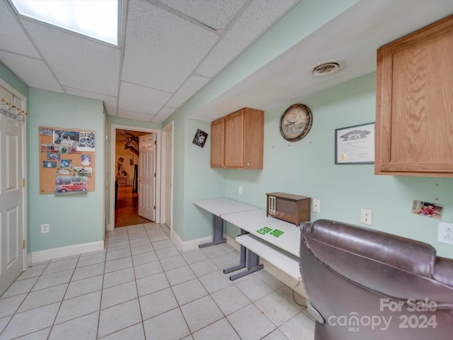 office area featuring a paneled ceiling and light tile patterned floors