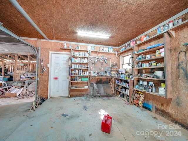 miscellaneous room featuring concrete floors and a workshop area