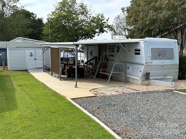 rear view of property with a patio, a storage shed, and a lawn