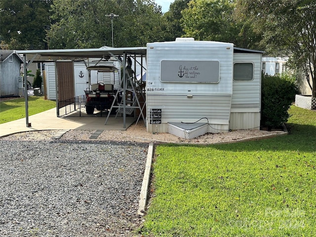 back of house with a yard and an outdoor structure