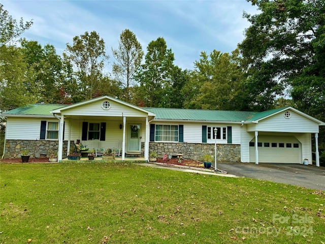 ranch-style house with a garage, covered porch, and a front yard