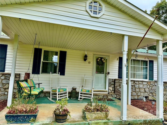 view of exterior entry with a porch