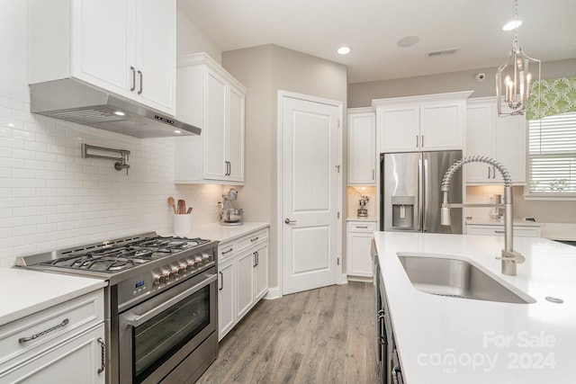 kitchen featuring white cabinetry, appliances with stainless steel finishes, sink, and light hardwood / wood-style flooring