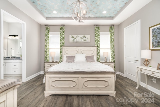 bedroom with multiple windows, dark hardwood / wood-style floors, and a tray ceiling