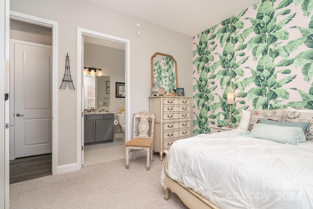 carpeted bedroom featuring ensuite bathroom