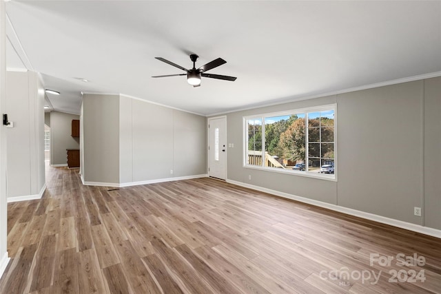 spare room with crown molding, light wood-type flooring, and ceiling fan