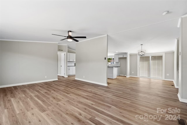 unfurnished living room with crown molding, light hardwood / wood-style flooring, and ceiling fan with notable chandelier