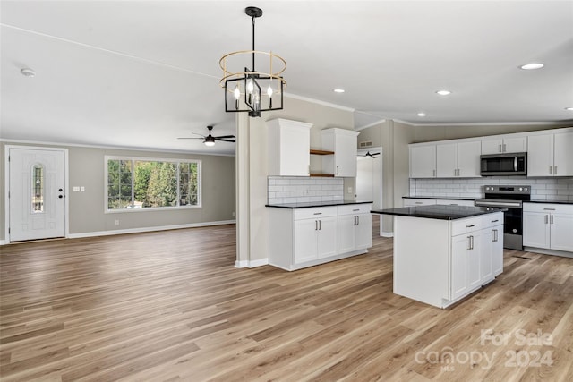 kitchen featuring light wood-type flooring, white cabinetry, stainless steel appliances, and ceiling fan with notable chandelier