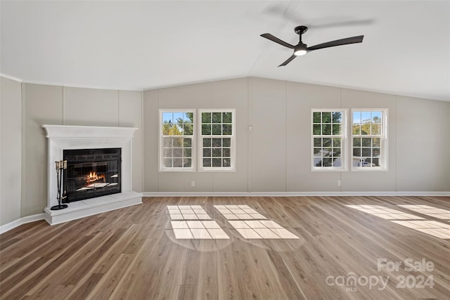 unfurnished living room with lofted ceiling, light hardwood / wood-style flooring, and a wealth of natural light