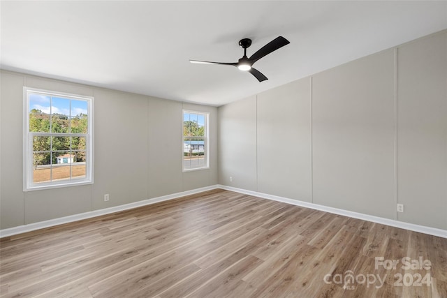 spare room with light hardwood / wood-style flooring and ceiling fan