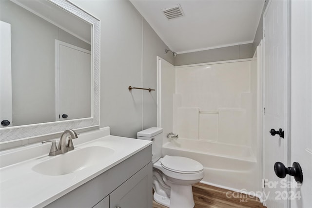 full bathroom featuring vanity, toilet, hardwood / wood-style flooring, and washtub / shower combination