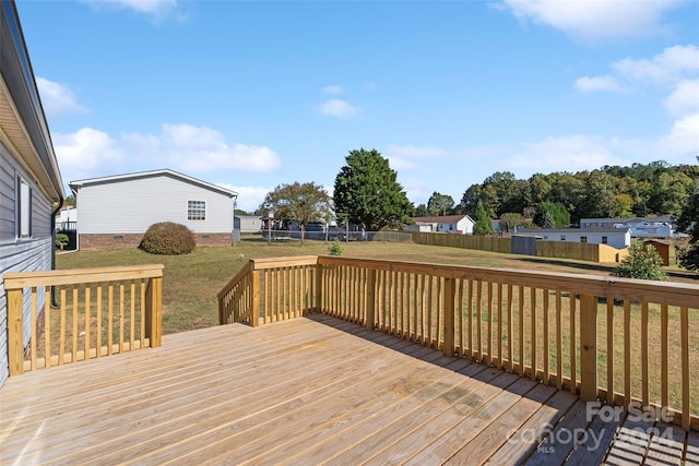 wooden deck featuring a lawn