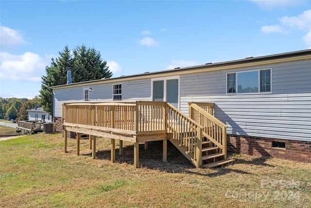 rear view of house with central AC, a yard, and a deck