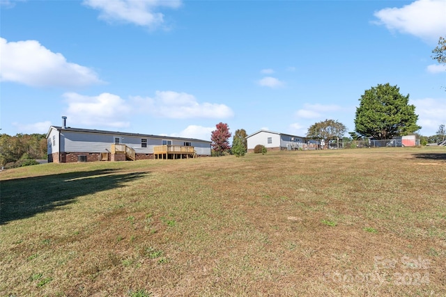 view of yard with a wooden deck