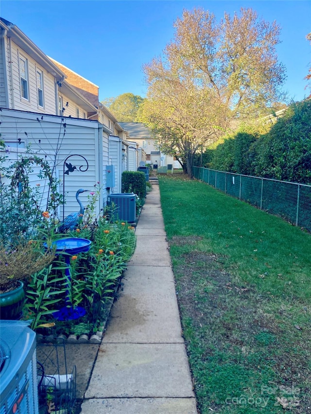 view of yard featuring central air condition unit