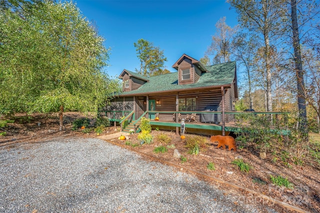 log-style house featuring covered porch