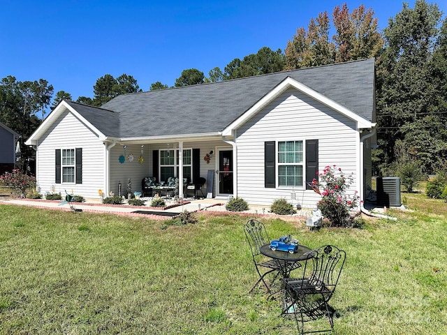 ranch-style home featuring central air condition unit and a front lawn