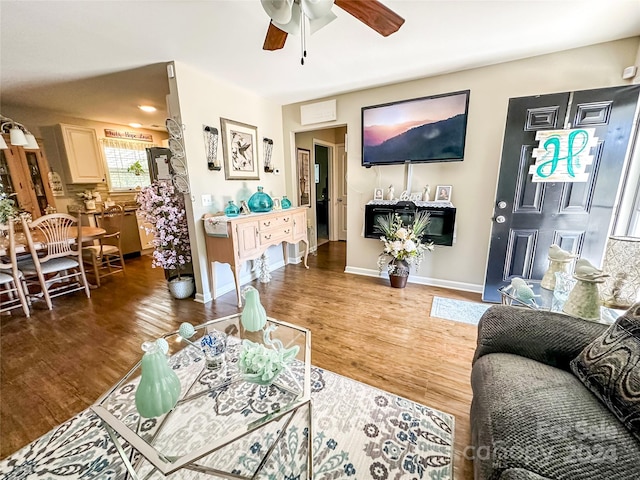 living room with ceiling fan and dark hardwood / wood-style floors