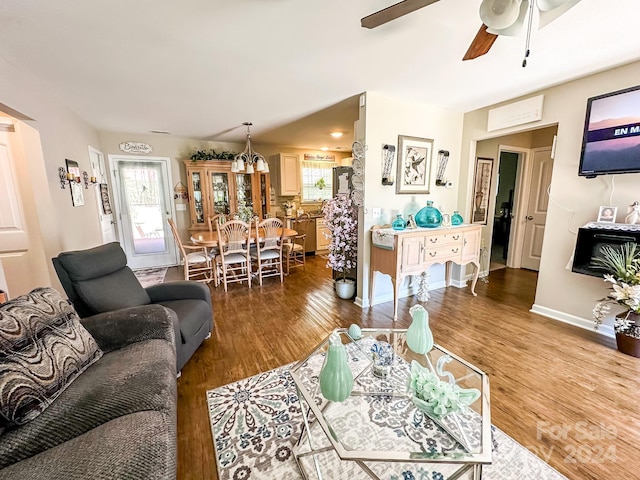 living room with hardwood / wood-style flooring and ceiling fan