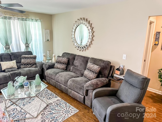 living room featuring ceiling fan and wood-type flooring