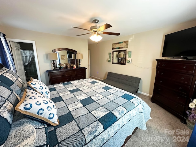 carpeted bedroom with a closet, ceiling fan, and a spacious closet