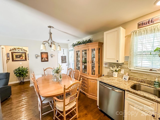 dining area with dark hardwood / wood-style floors and a chandelier