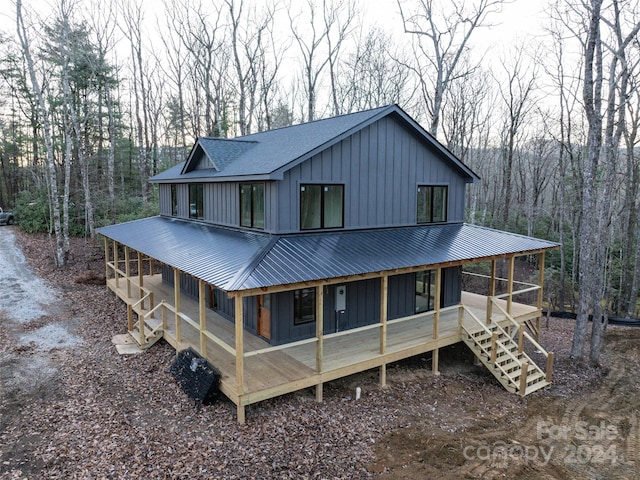 rear view of house with covered porch