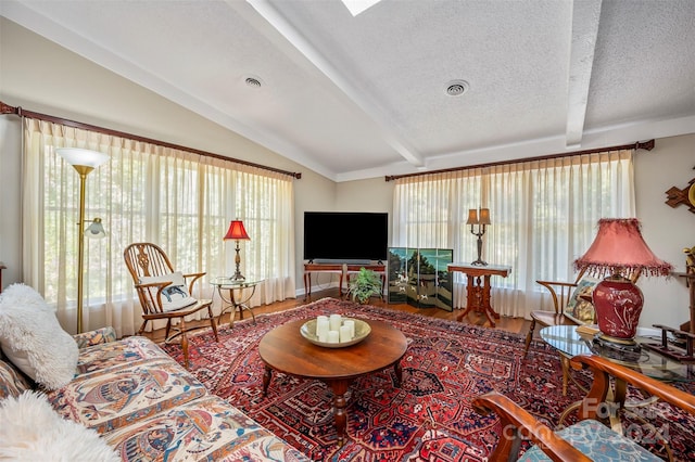 living room with vaulted ceiling with beams, a textured ceiling, and hardwood / wood-style flooring