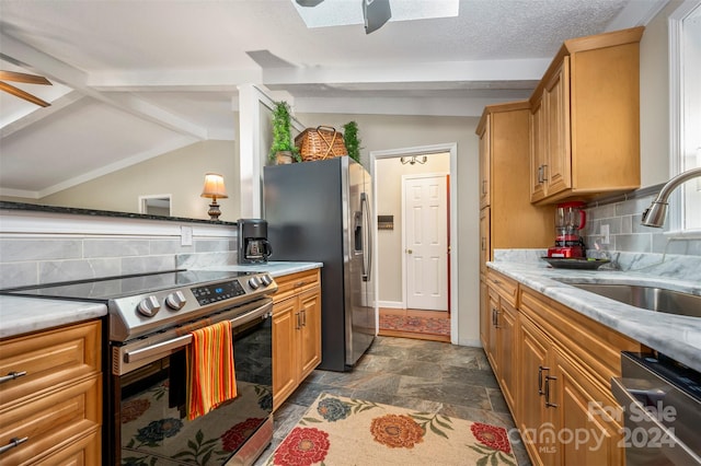 kitchen with lofted ceiling with skylight, ceiling fan, stainless steel appliances, and backsplash